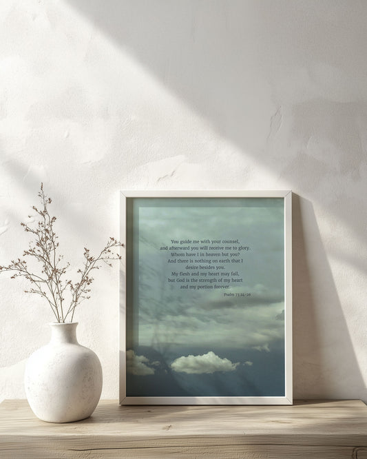 Framed Scripture art print with Psalm 73:24-26 on a sky with calming blues and grays and puffy white clouds. The print is on a wooden surface with a vase.